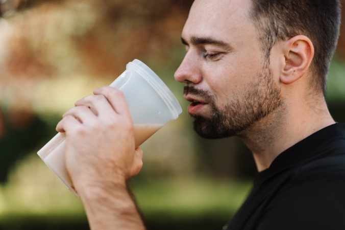 A Man Sips a Protein Shake